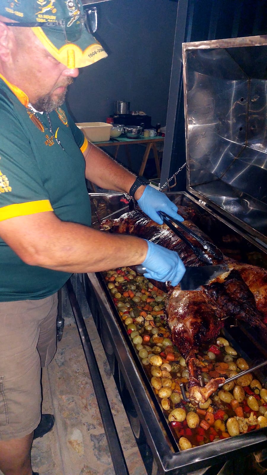 Spit braai meat being carved and served